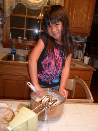 Kasen helping with Thanksgiving cooking (making cake)